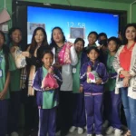 कक्षाको स्क्रिनअगाडि कपडाका झोला समातेर उभिएका विद्यार्थी र तीन महिला अतिथि