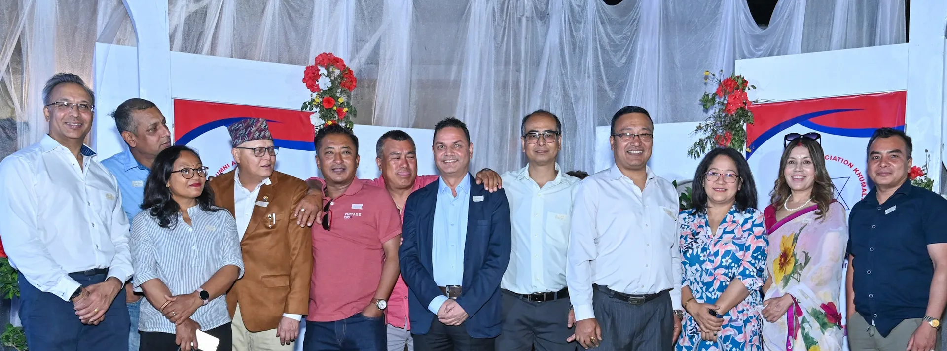 A group of alumni on stage at the AAAK reunion
