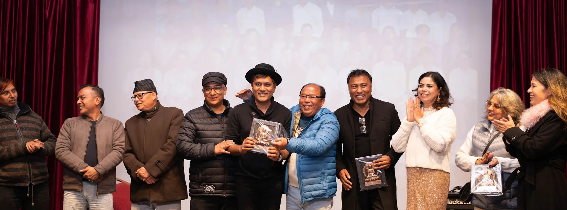 Tokens of appreciation presented on stage at an AAAK programme